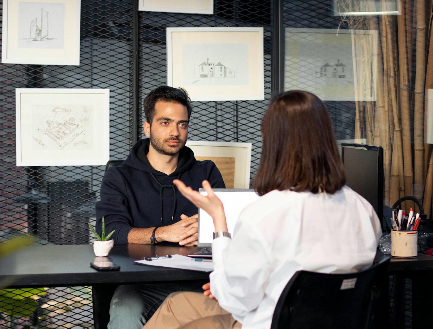 Attorney at a desk talking with a client
