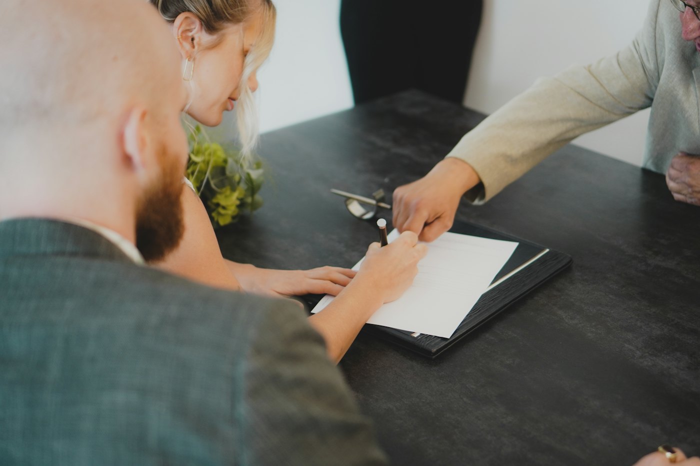 Couple reviewing and signing a document together