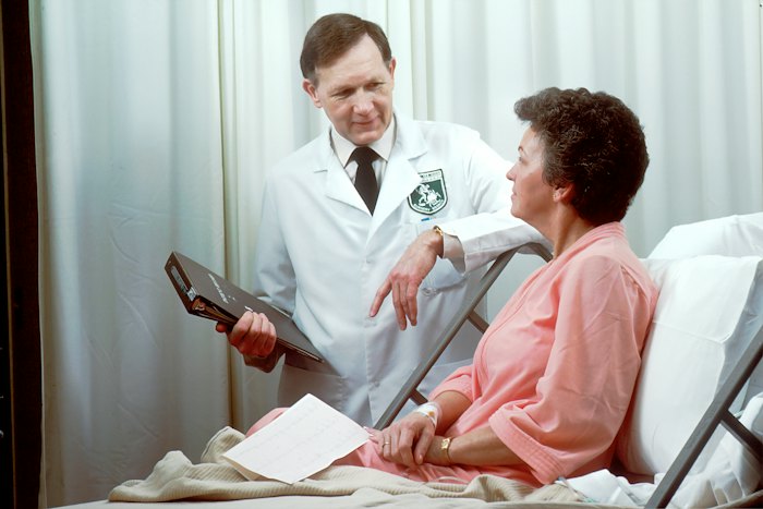 Doctor talking to a patient in a hospital bed