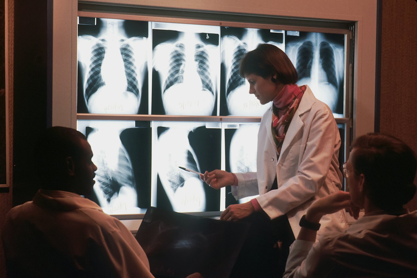 Doctor talking to a patient in front of an x-ray