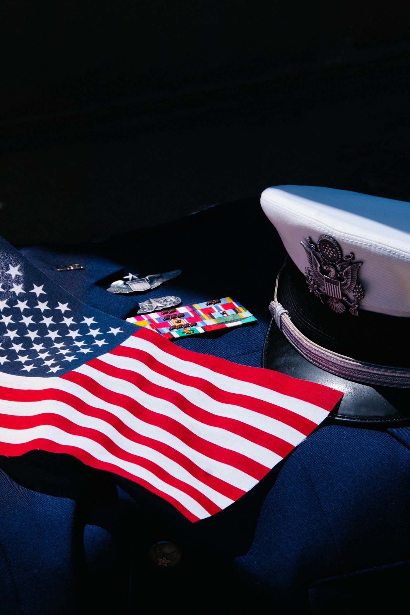 American flag resting on a military dress uniform