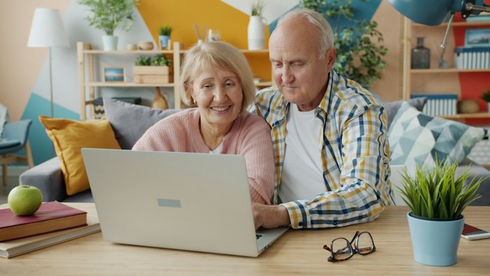 Older couple looking at a laptop together at home