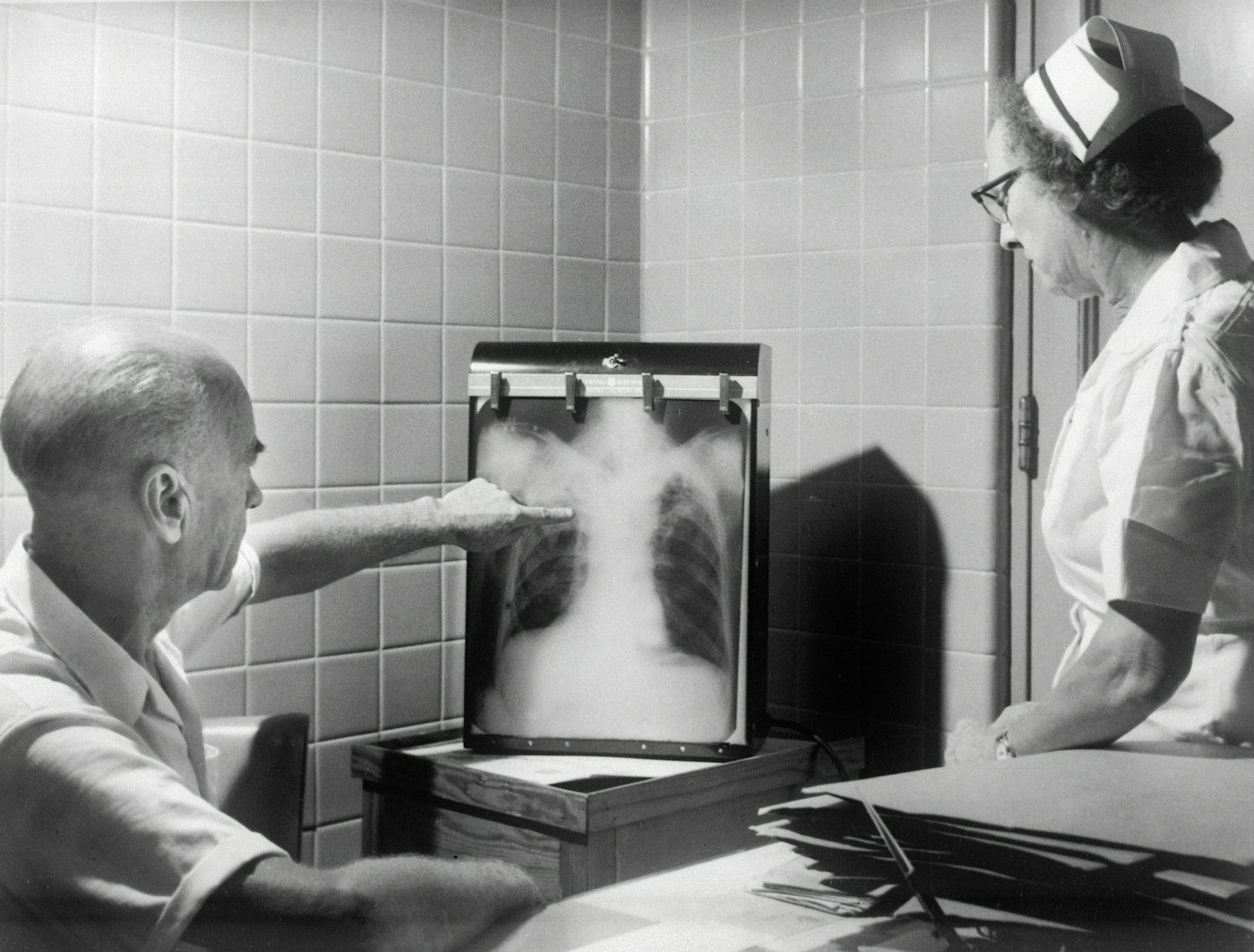 Two people looking at a chest x-ray
