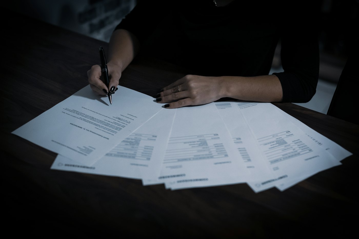 Woman sitting at a table with paperwork